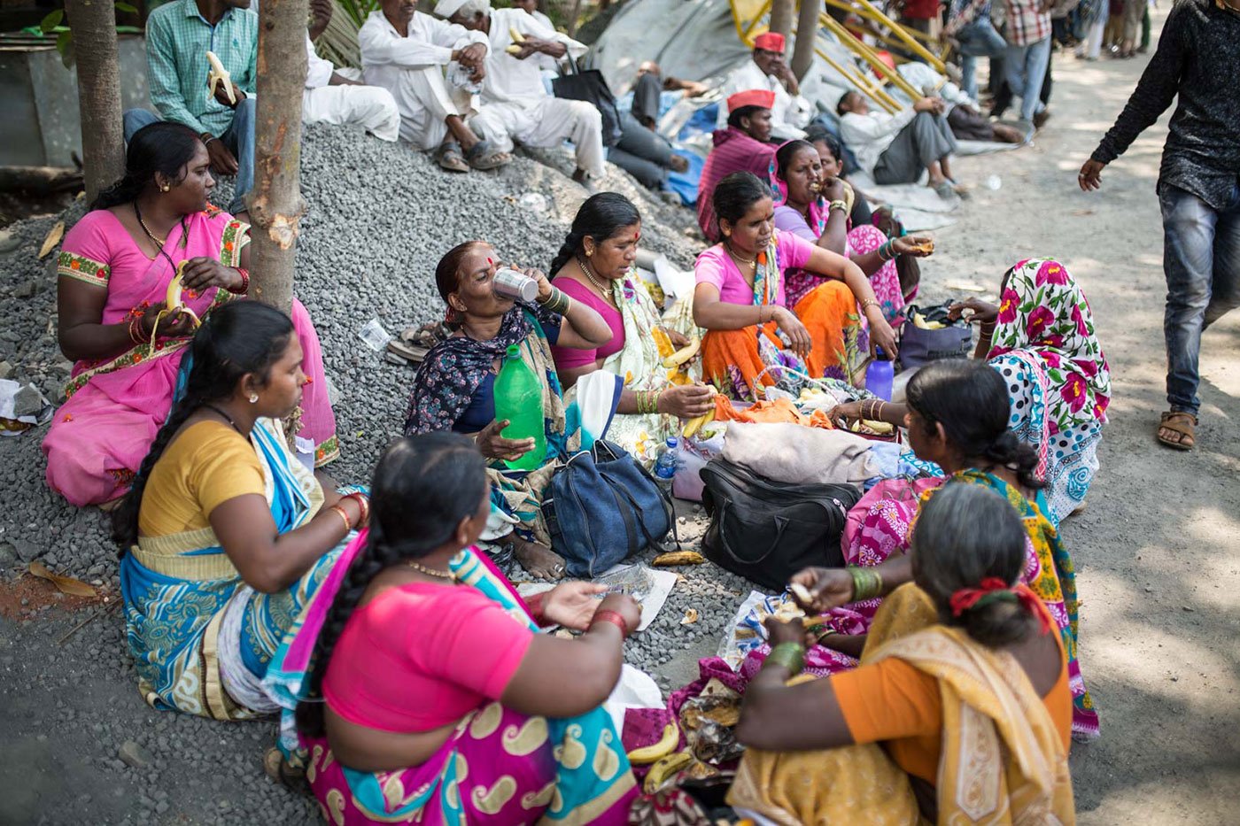 A group of women, including Shantabai Waghmare, 50, eating lunch