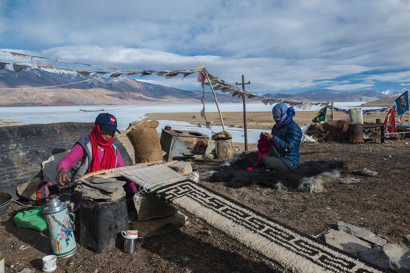 In Korzok village, Tsering Norzom and Sanoh Dolkar are unperturbed by the freezing winds blowing over the frozen Tso Moriri lake. They are busy making a carpet and sweater with wool from their own herd of goats and sheep