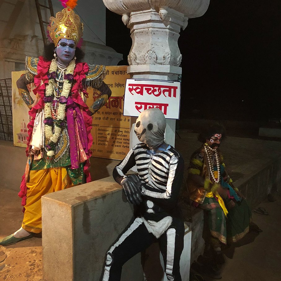 actors in their get up standing outside the temple