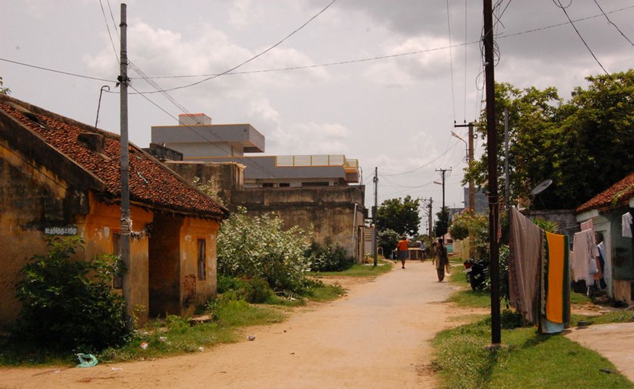 Left: A street in Arani. The tall house, painted grey and yellow, belongs to Mohan. 