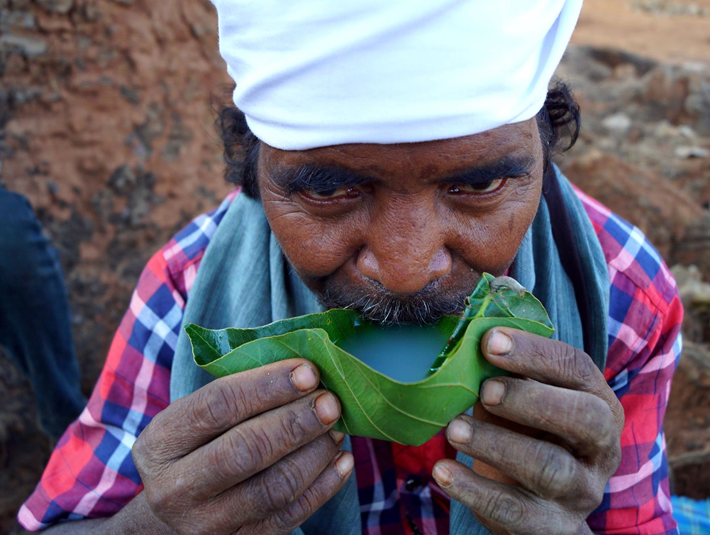 A man drinking mahua wine