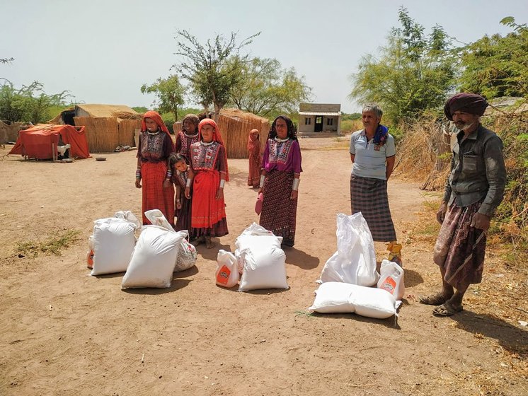 Left: Pastoralist families receiving ration bags from Bhikhabhai Vaghabhai Rabari, president of the Kachchh Unt Uchherak Maldhari Sangathan (Kachchh Maldhari Camel Herders Organisation). Right: Several Fakirani Jat families have received such ration kits from a Bhuj-based organisation working for the rights of the maldharis. The bags include essentials like wheat, lentils, cotton oil, turmeric, spices, salt and rice. The families say this has reduced the pressure on them greatly.

