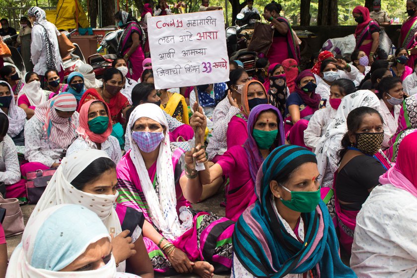 An ASHA dressed as Durga (left) during a protest outside the Collector’s office (right) in Kolhapur. Across India, ASHA workers have been demanding better working conditions, employee status, monthly salary and timely pay among other things