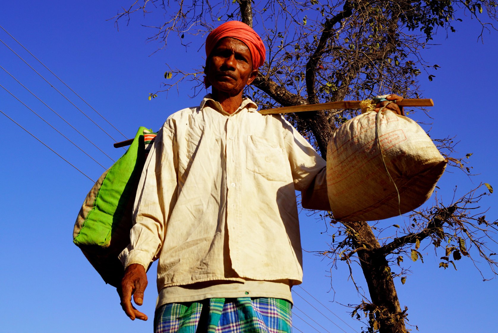 Itwaru, a farmer and farm labourer from nearby Kohcur village, is here to purchase mahua flowers and grapes to make wine