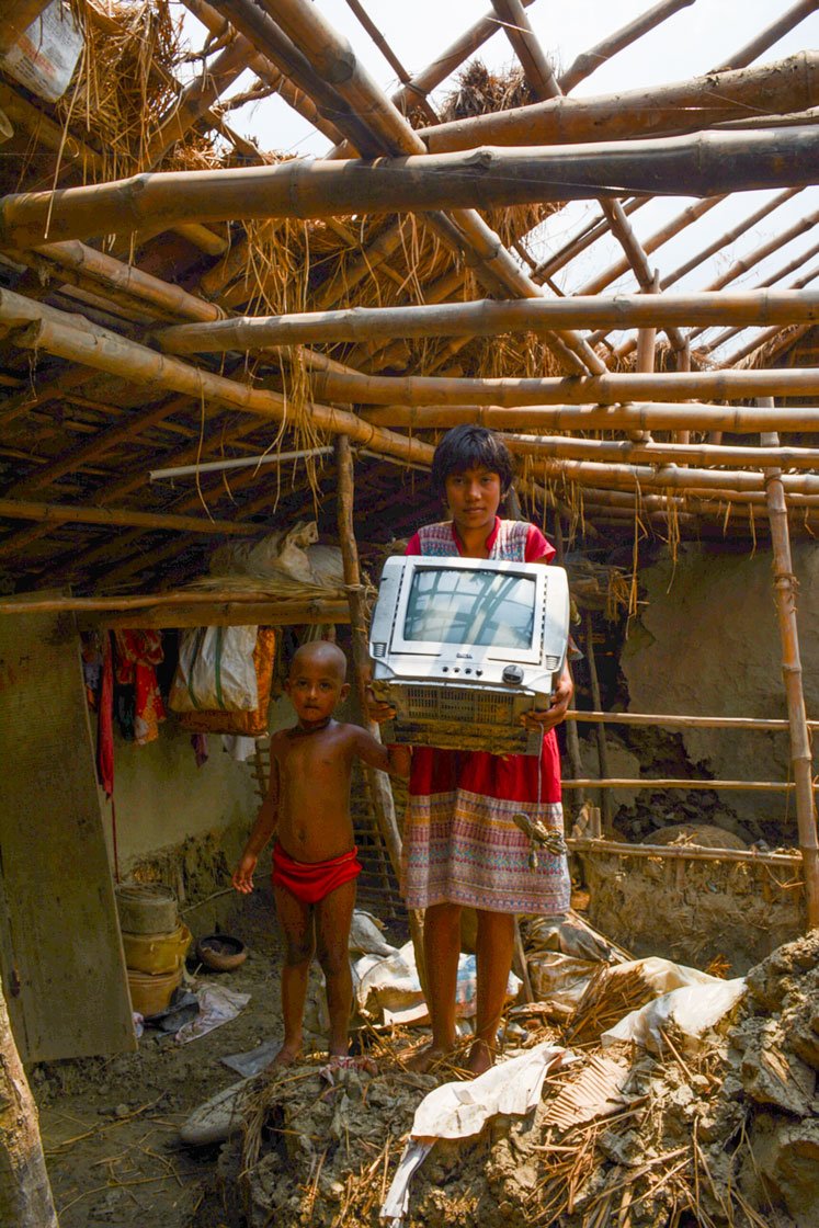 Left: Debika Bera, a Class 7 schoolgirl, in what remains of her house in Patharpratima block’s Chhoto Banashyam Nagar village, which Cyclone Amphan swept away. The wrecked television set was her family’s only electronic device; she and her five-year-old sister Purobi have no means of 'e-learning' during the lockdown. Right: Suparna Hazra, 14, a Class 8 student in Amrita Nagar High School in Amtali village, Gosaba block and her brother Raju, a Class 3 student

