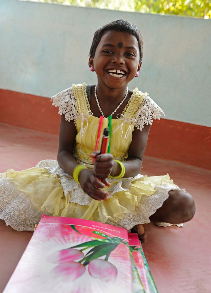 Binata Hembram, 8, is always smiling radiantly, and clearly loves her school work