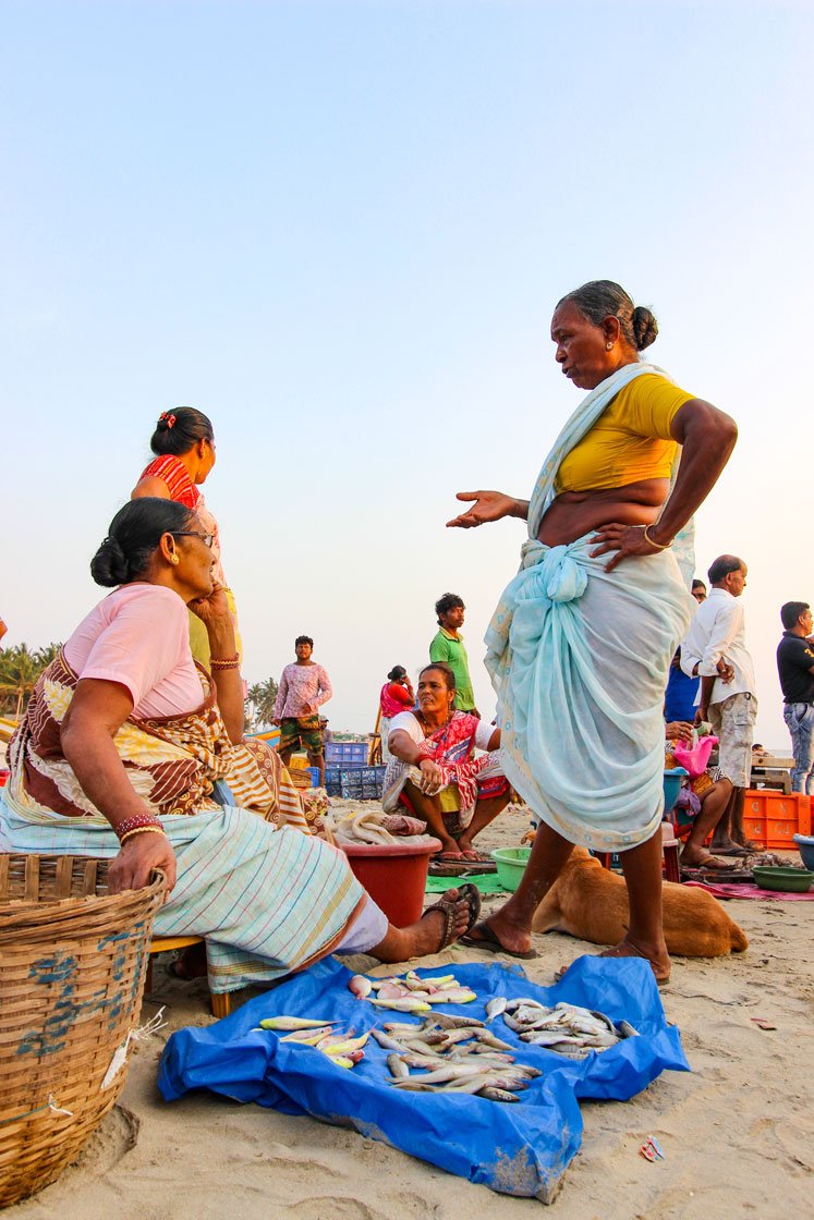 Selling her fish in the evening auction (left) and everyday banter at the evening auction (right). The last Marine Fisheries Census (2010) records about 4 lakh women in the post-harvest workforce in marine fisheries (involved in all activities except the actual fishing process)

