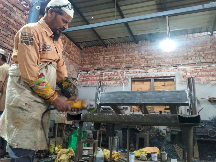 Right: Babu Khan, 60, is the oldest karigar at the factory and performs the task of buffing, the final technical process