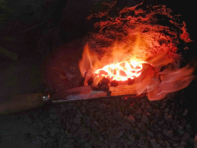 The lohar adds final touches to the sickle (left) and puts it inside the forge (right)