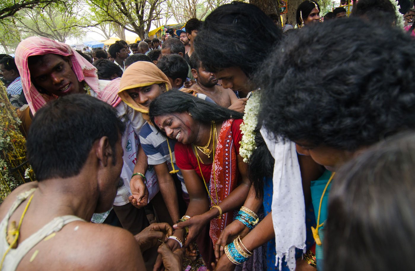 A priest breaks an aravani’s bangles – one of the rituals of widowhood. Visibly distraught, she begins to sob.  Many visitors stand around watching the rituals