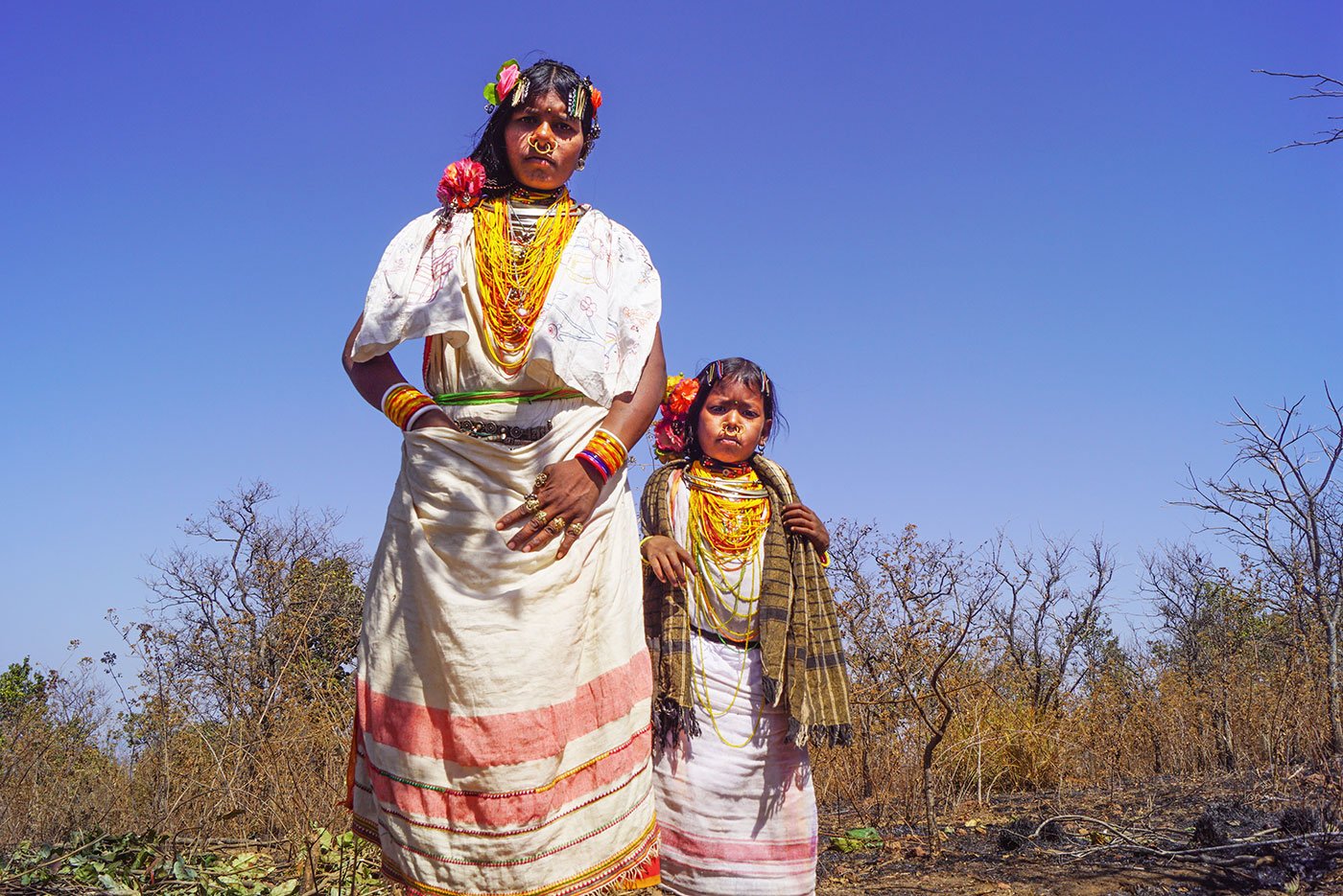 A tribal woman and a young tribal girl in their traditional attire