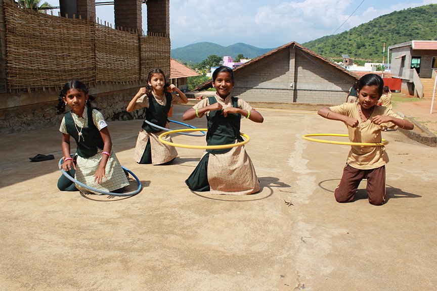 four girls playing with hoops