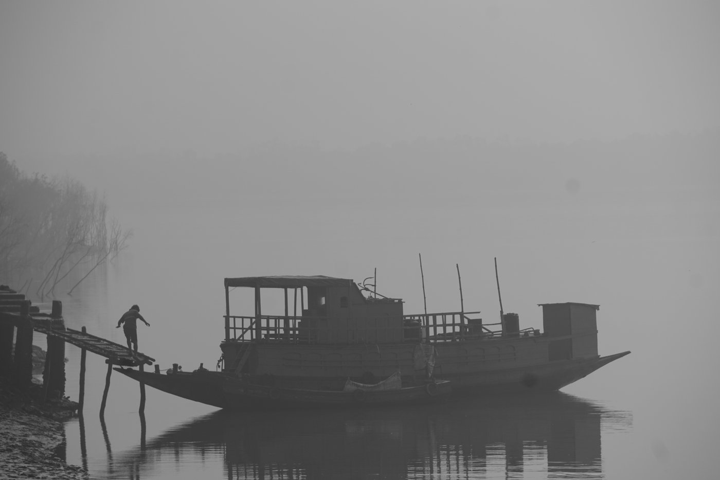 Man getting on ferry on a foggy day