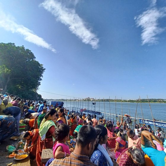 The crowd at Amma Mandapam (left), a ghat on the Cauvery on the occasion of Aadi Perukku where the river (right) is worshipped with flowers, fruits, coconut, incense and camphor.