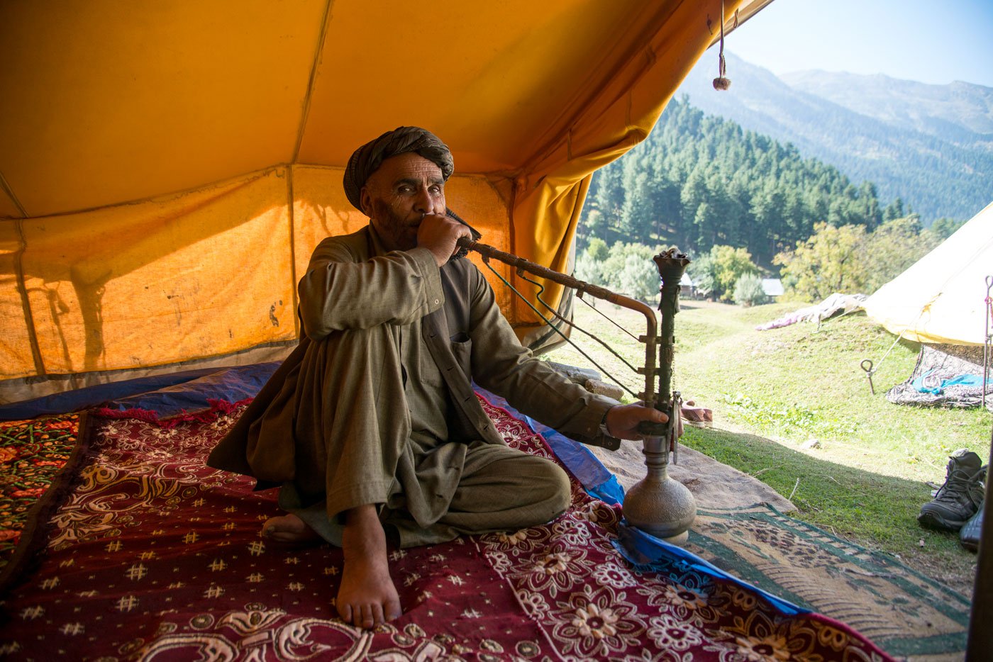 Mohammad Yunus relaxing in his tent with a hookah