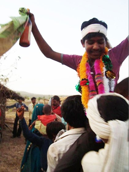Marriage is an occasion for celebration and the young bridegroom has been lifted up on the shoulders of one of his dancing kinsmen