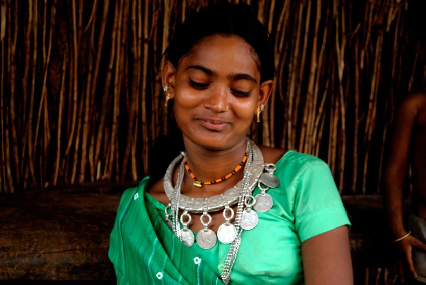 An Adivasi bride wearing traditional silver jewellery in preparation for marriage