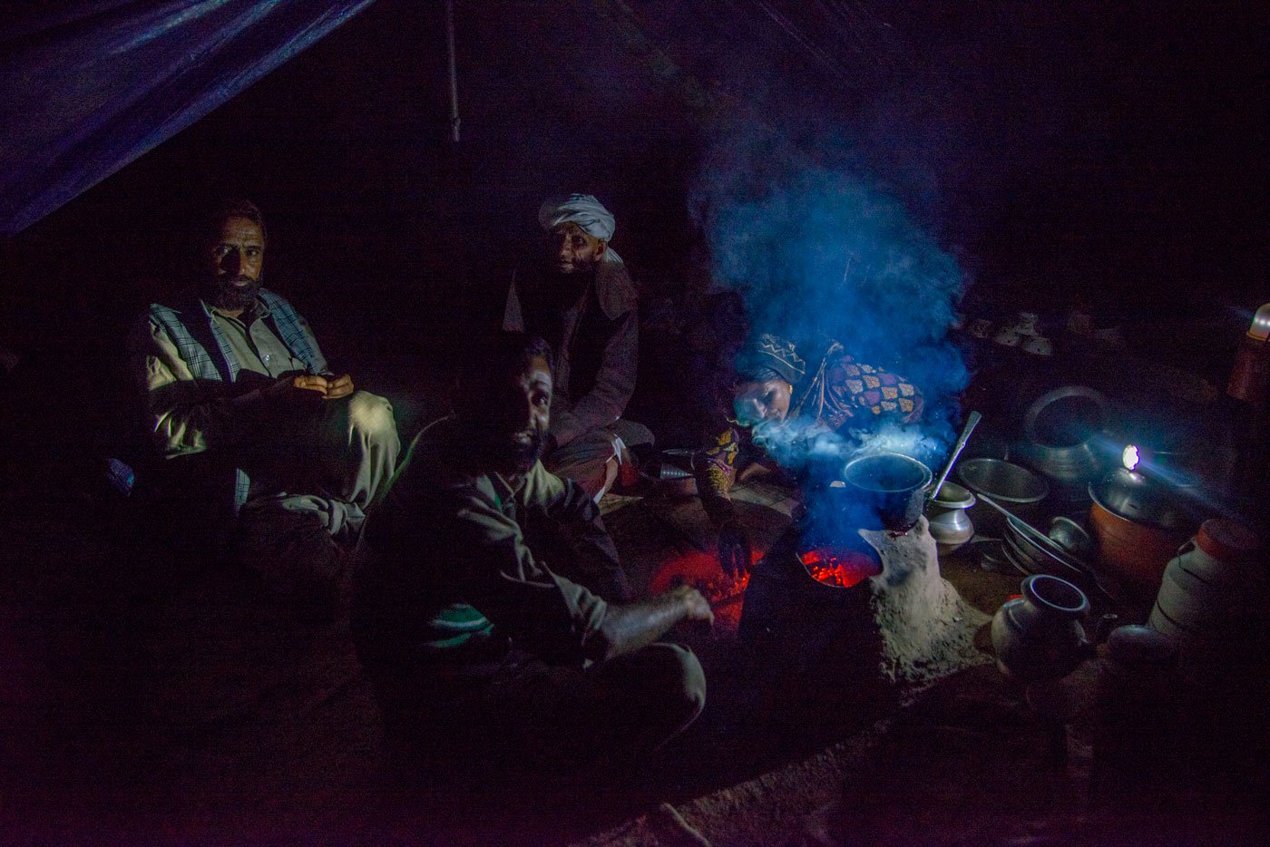 A Bakarwal family preparing dinner in their tent