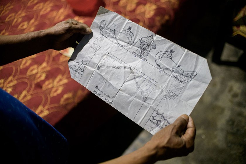 Ramesh Dutta (left) shows a hand-drawn set design for the Raas Mahotsav. In the auditorium of the Garamur Saru Satra, he gets the set ready for the 2022 Raas performances