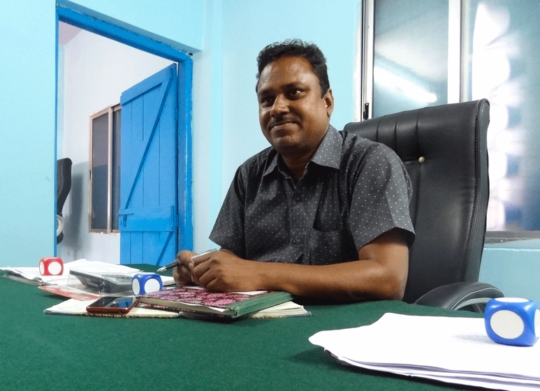 Vinod Meshram, the village development officer, sitting in the modest gram panchayat office of Baranj Mokasa.