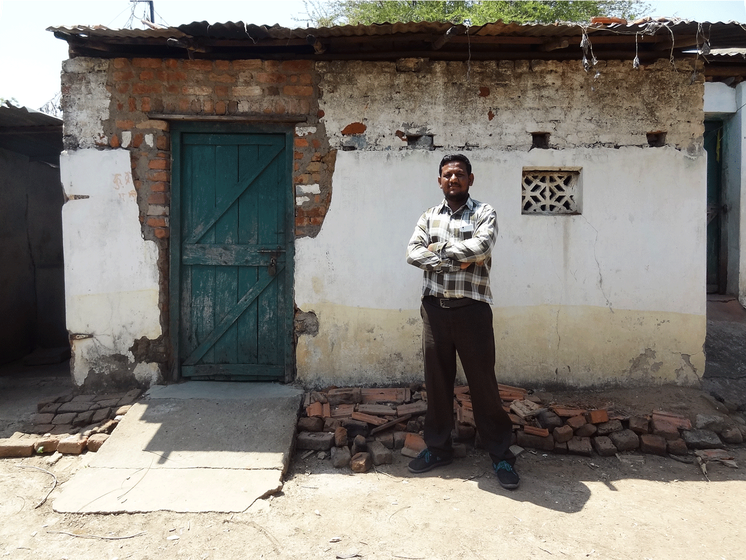 Sachin Chalkhure, a young Dalit activist, standing near his abandoned house.