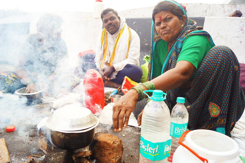 Laxmibai Kharat cooks for her family on the side of the road.