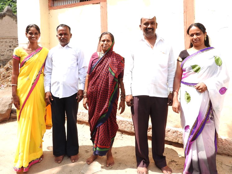Anjabana bai standing with sons and daughters-in-law outside home 