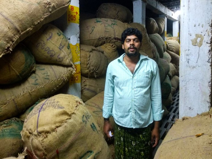 Man standing amid sacks of chillies in cold storage