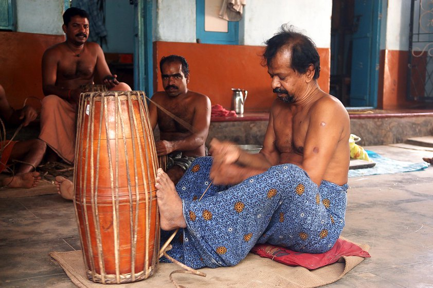 Left: K. Manikandan fastens the leather straps of a mridangam. Right: Ramesh and Rajeevan Lakshmanan finish a maddalam