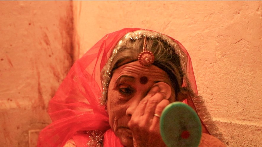 A old women getting ready to perform Terah Taali dance