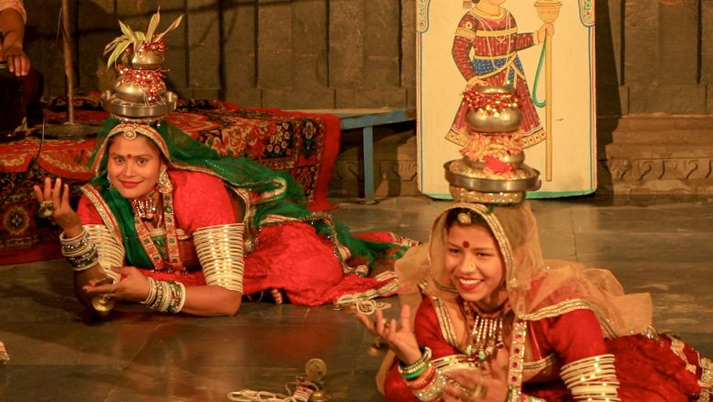 Two women are performing traditional Terah Taali dance Rajasthani dance