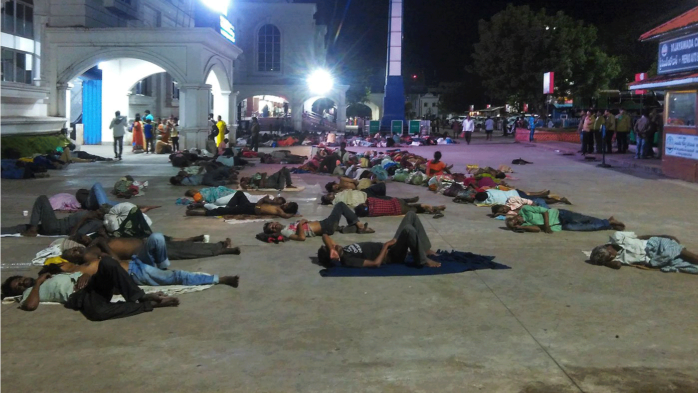 Migrant workers sleep outside railway station