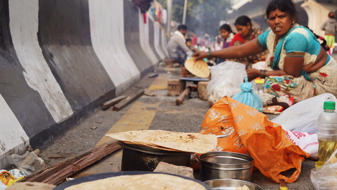 Woman cooking on the street