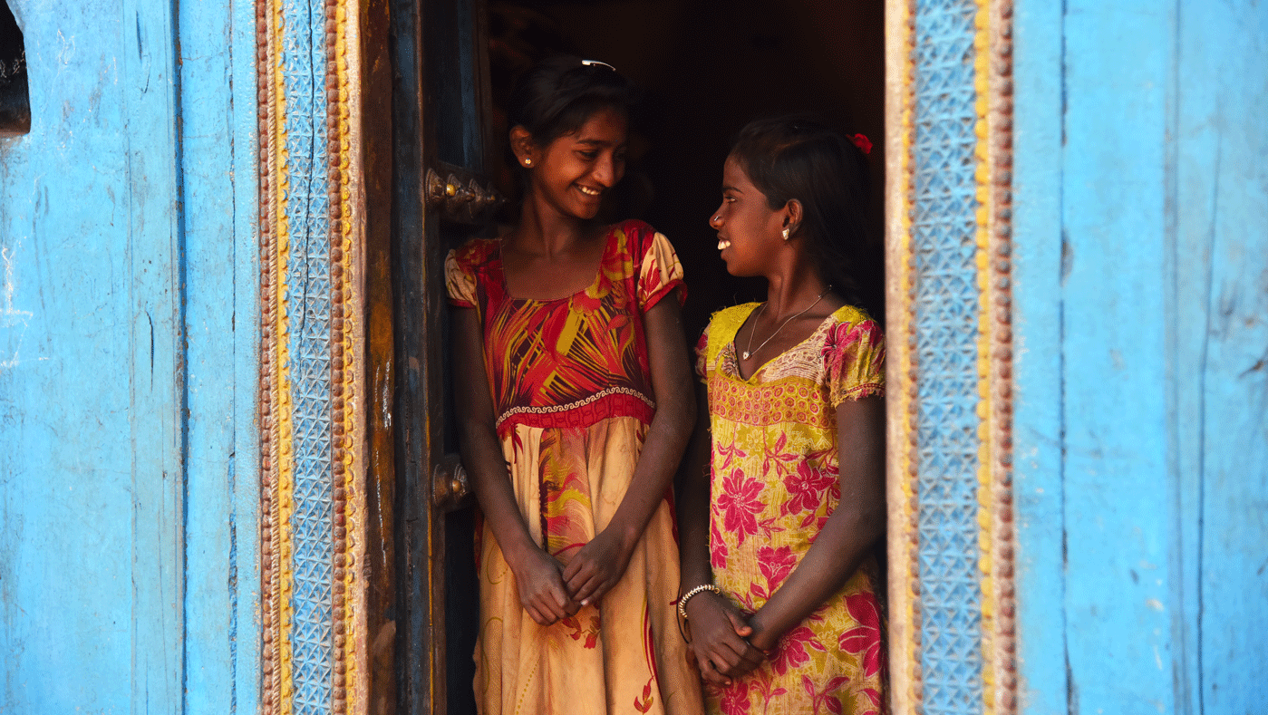 Two girls smiling in doorway