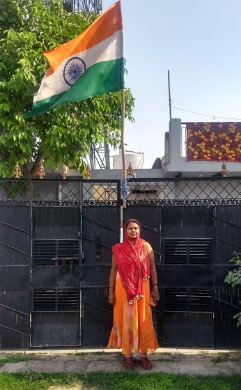 Woman posing by the national flag