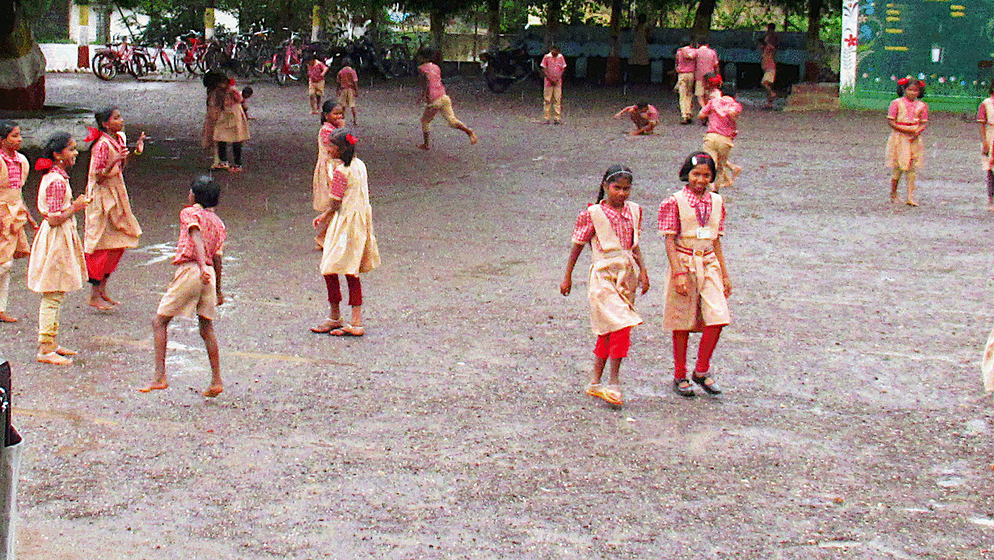 Children playing in school ground; rain