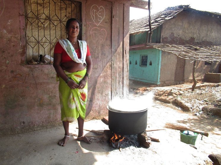 Lakshmi Digha cooking outside her house