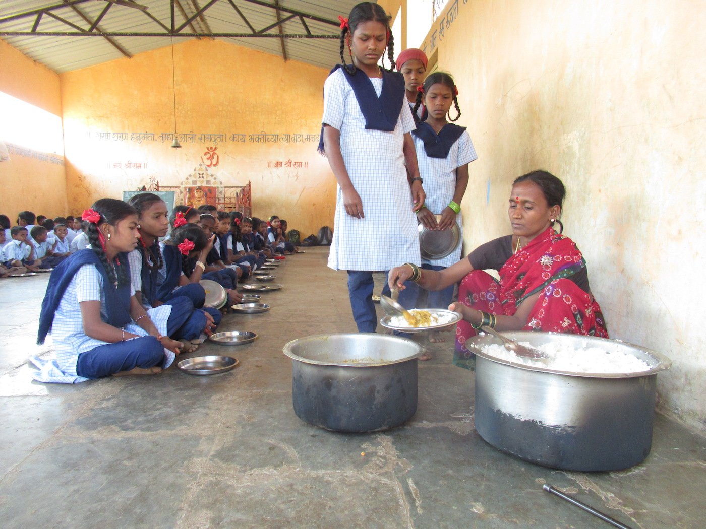 Students wait for their turn while the meal is being served