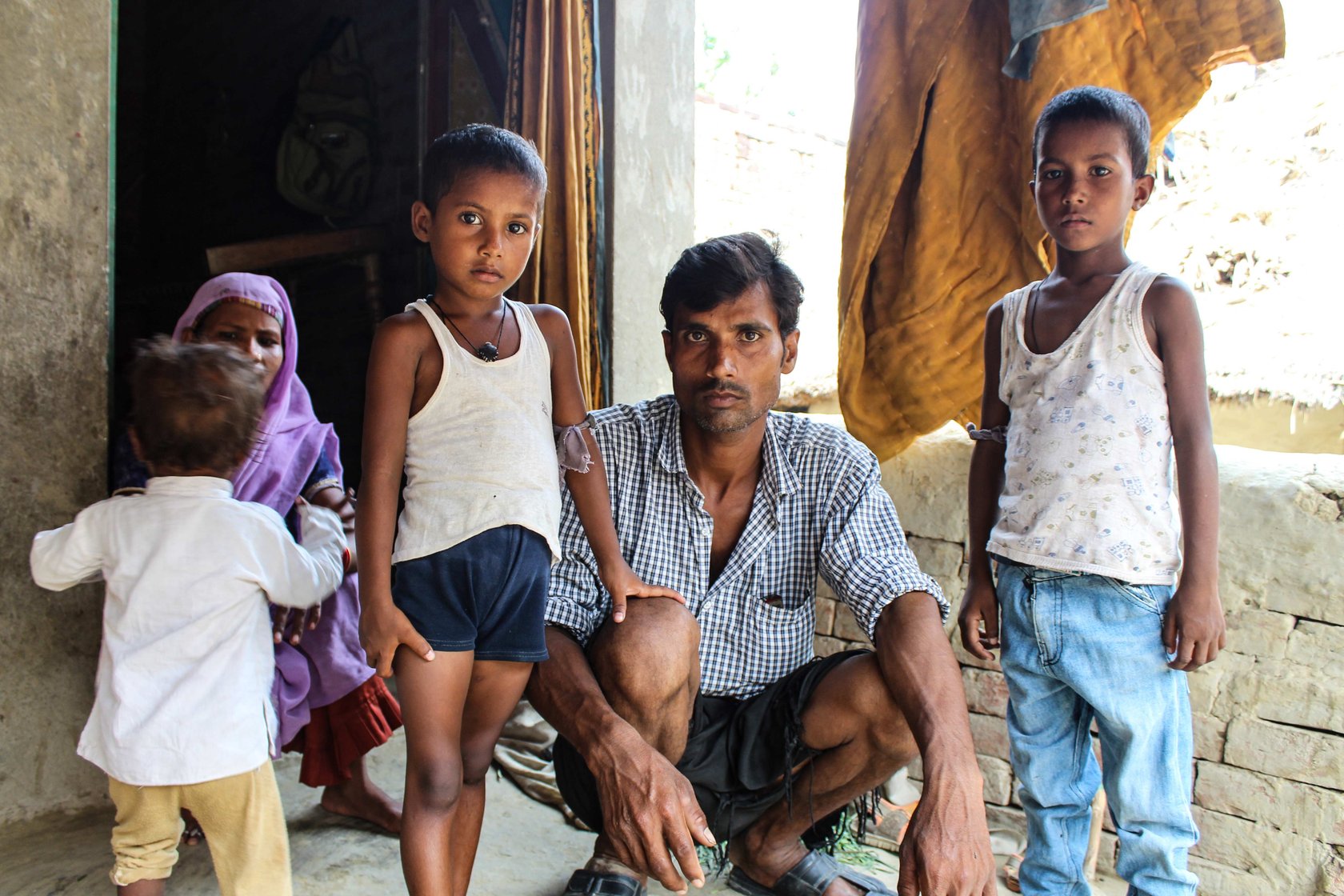 Pramod Kumar, Meenu Devi and their three children outside their house in Dadeora village of Uttar Pradesh