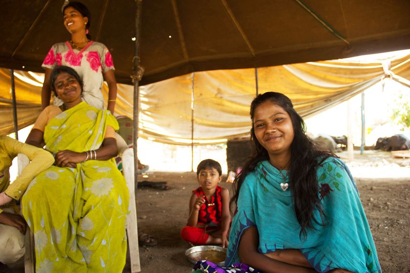 Jyotsna (left) and Kajal Shinde (right, in blue) at a stop in Karavadi village of Satara district: the sisters support their family of eight with their earnings