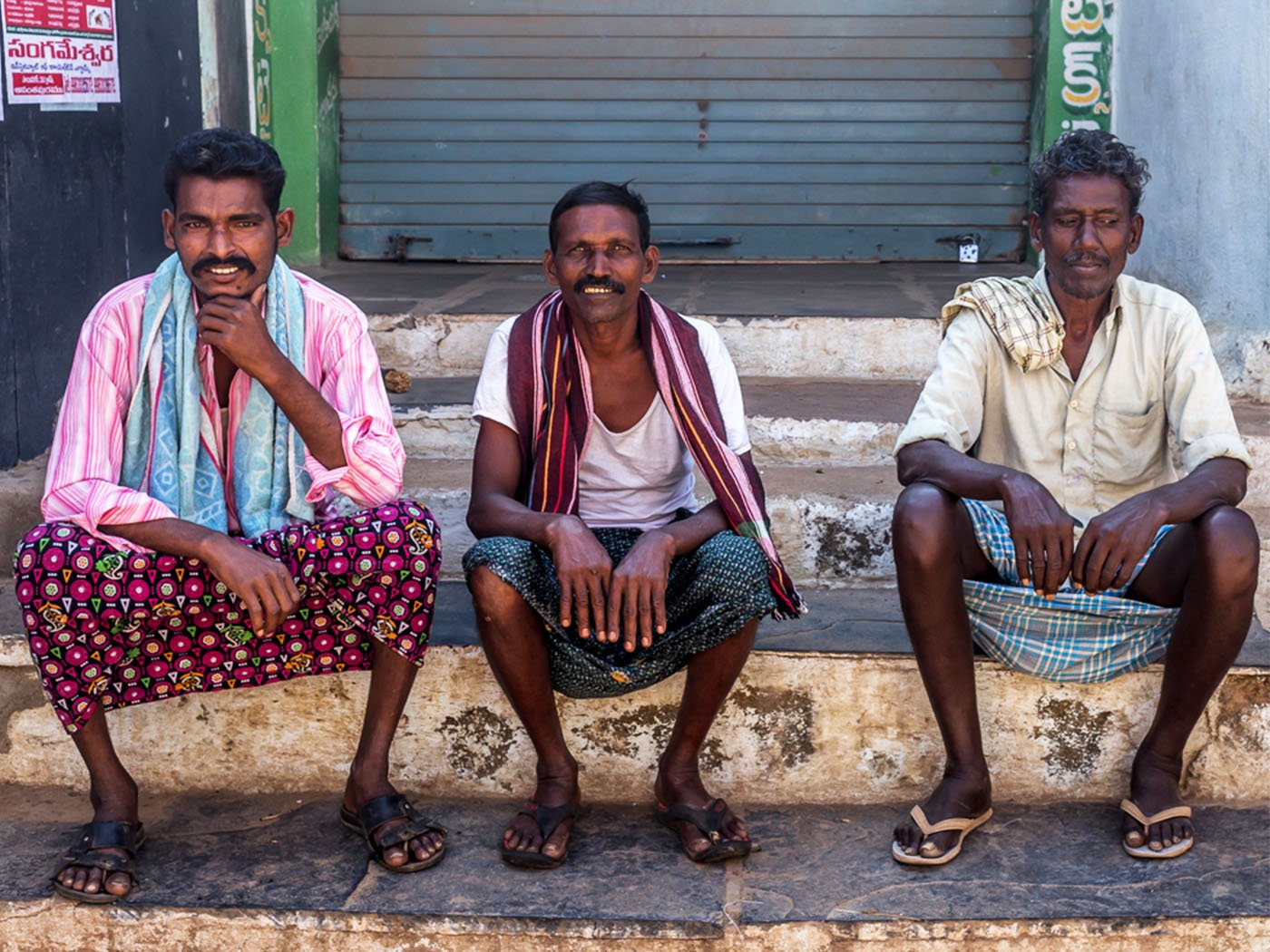 Farmers sitting in front of local shop