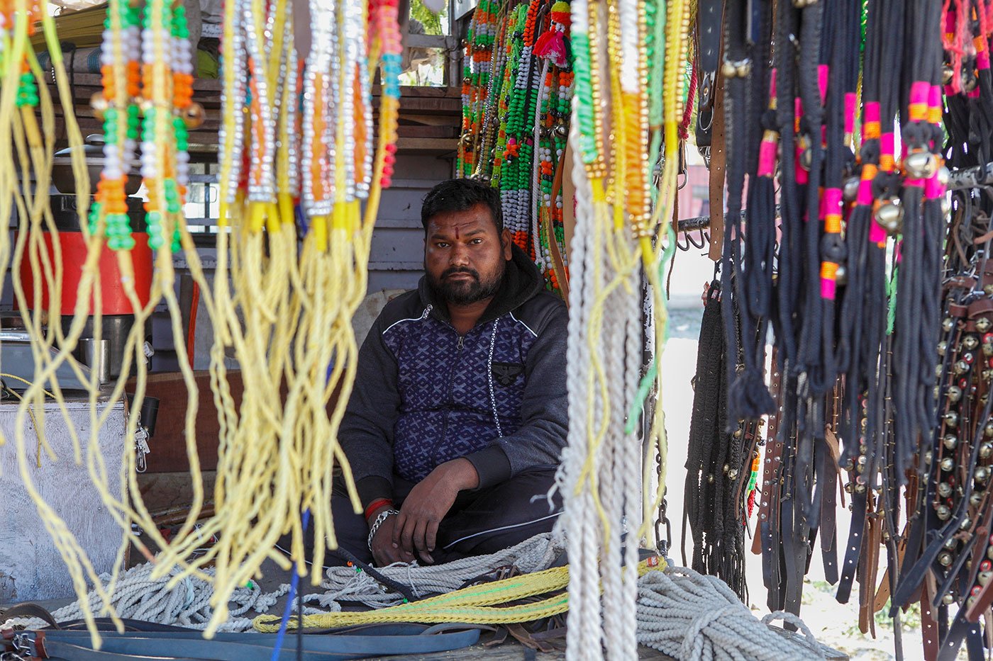 Man selling goat trinkets