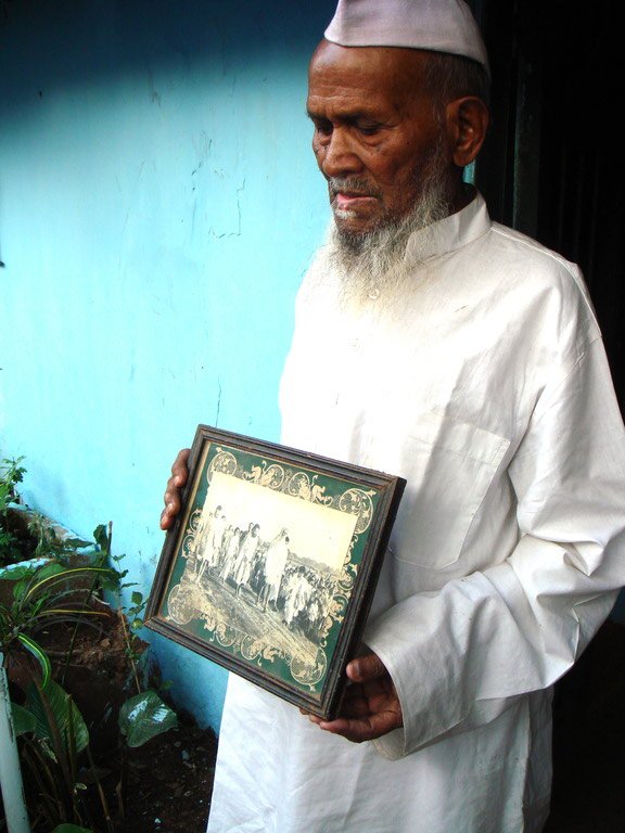 Old man with frame in hand