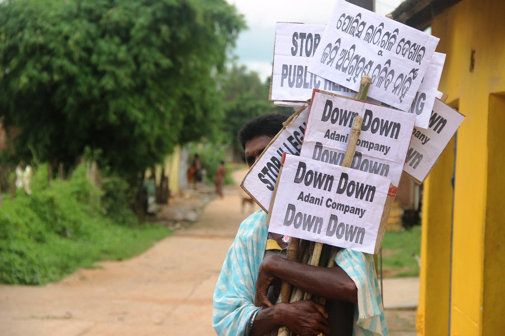 a villager with protest placards
