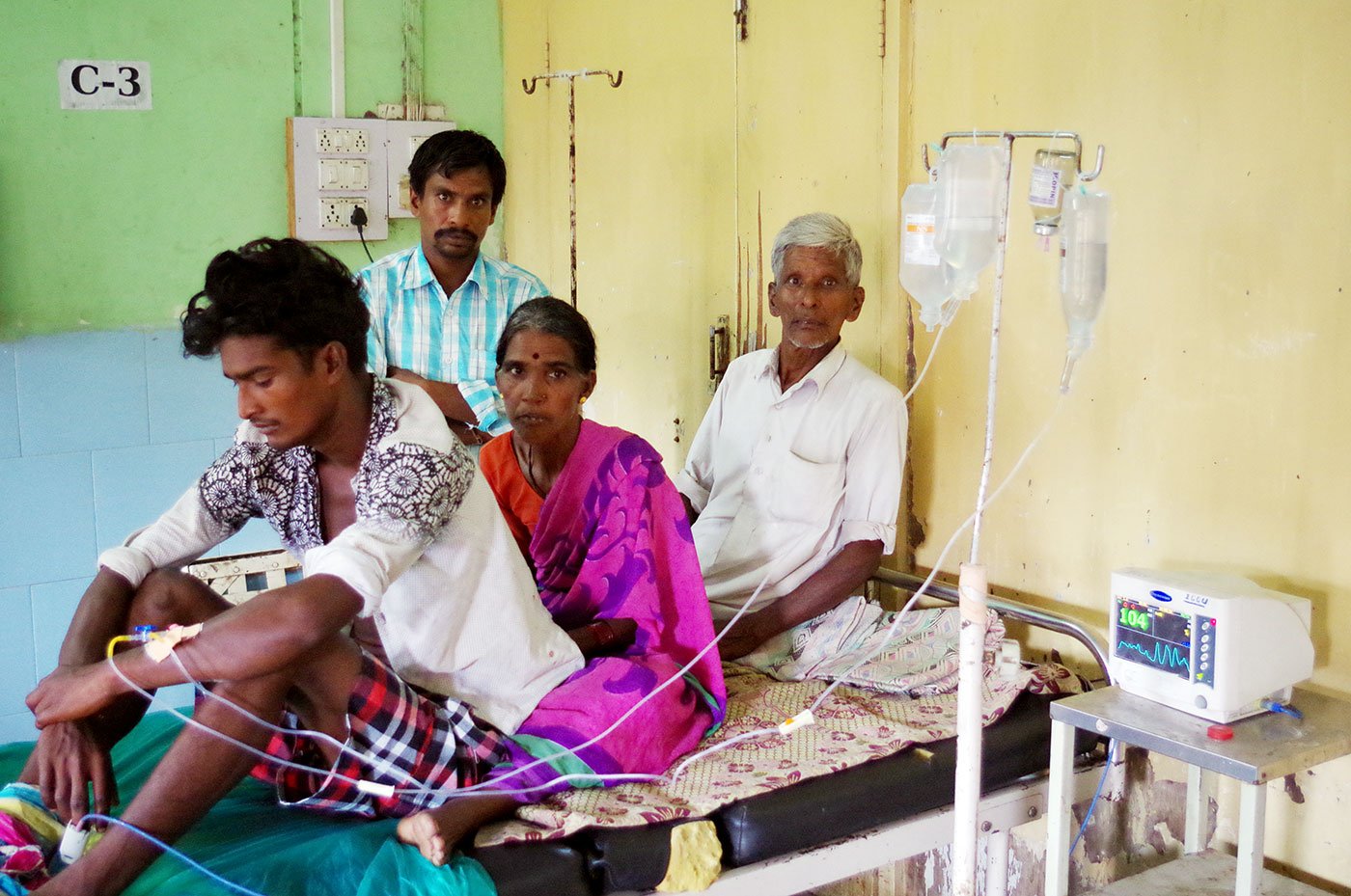 Nikesh Kathane, a 21-year-old farm labourer, recuperating in the ICU of the Yavatmal Government Medical College and Hospital in September 2017, after falling sick in the wake of accidental inhalation of pesticide while spraying it on his owner’s field. With him are his parents Keshavrao and Tarabai and his elder brother Laxman