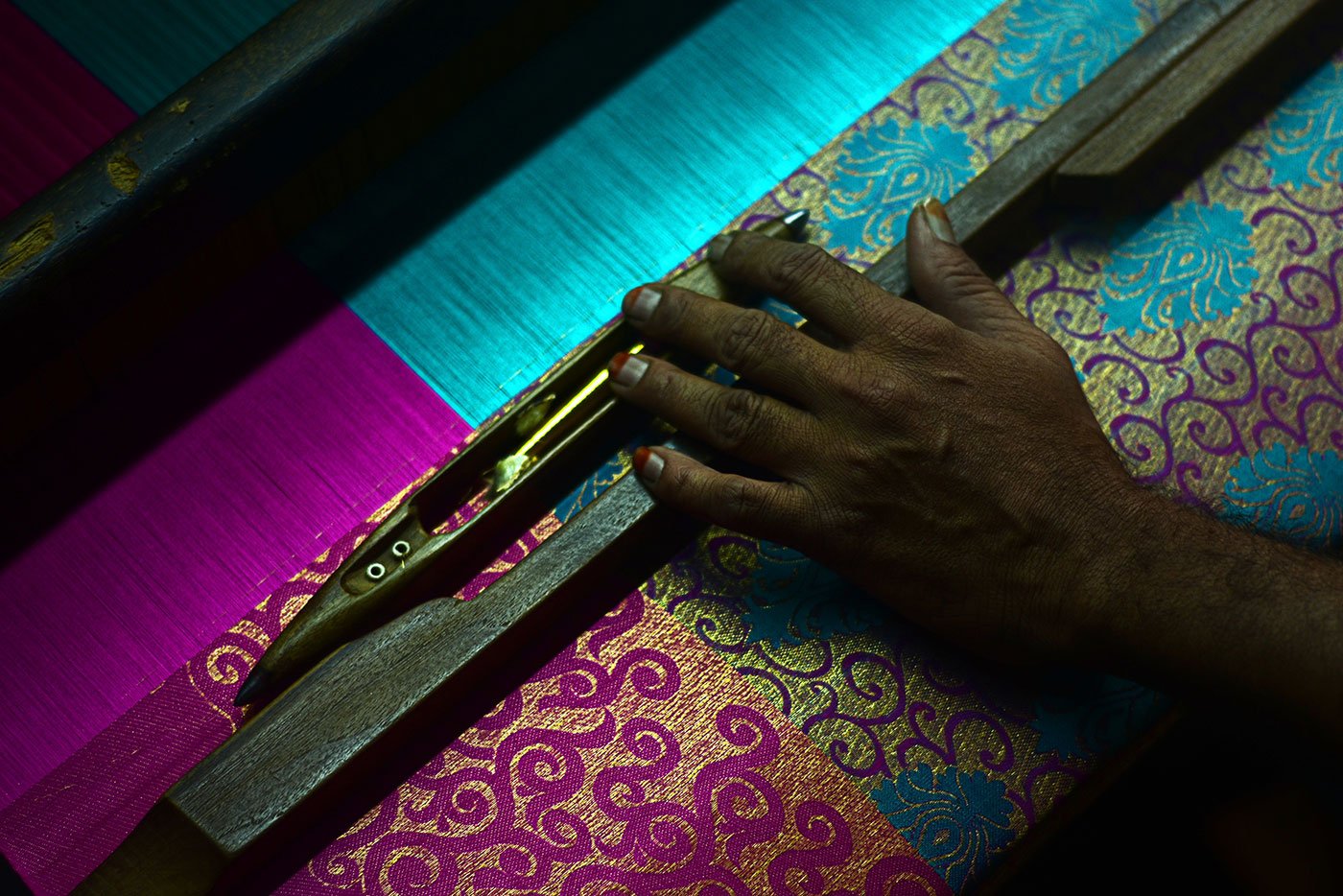 A man weaving on the machine