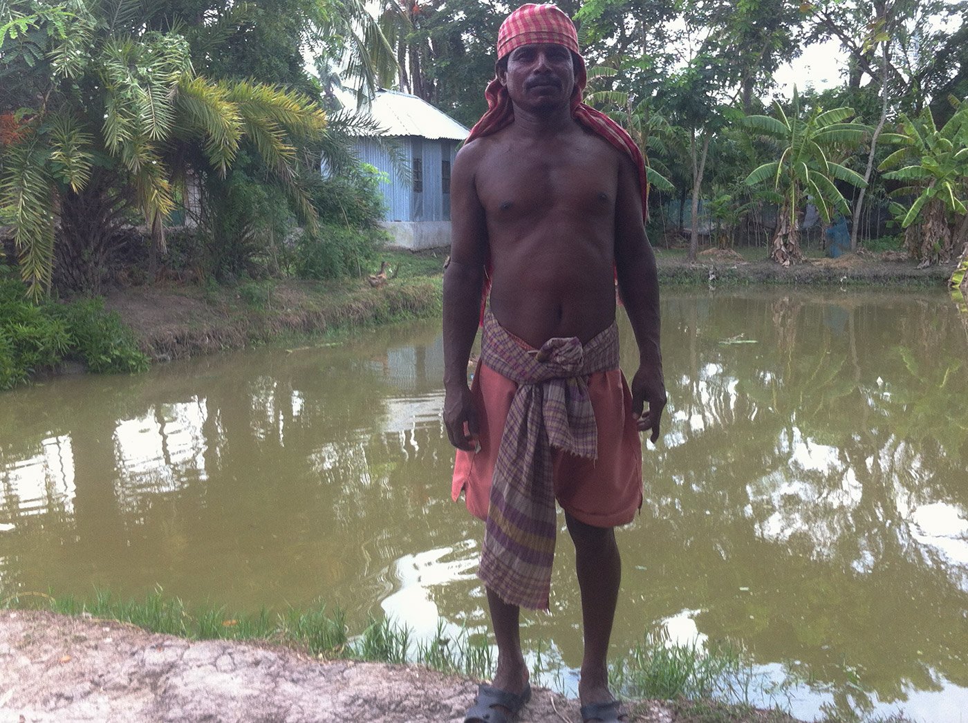 Nitai Joddar standing in front of pond