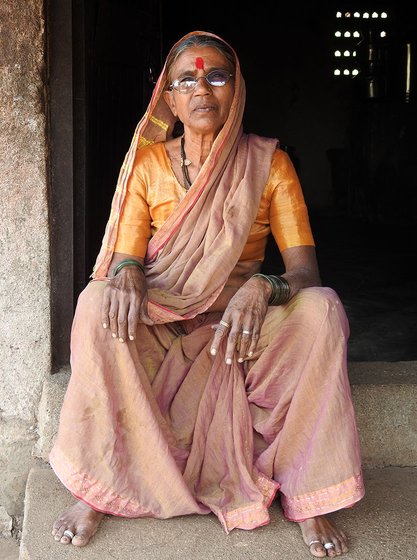 Woman sitting in the doorway of a house