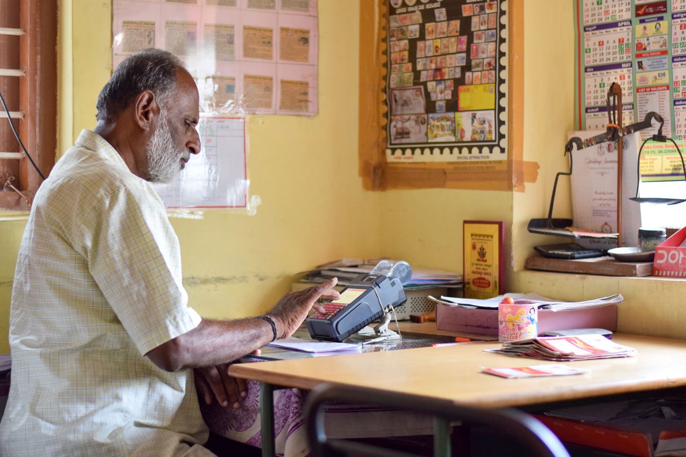Renuka at work as a Gramin Dak Sevak (Rural Postal Service) in his office in Deverayapatna town in Tumkur district; and six villages fall in his jurisdiction