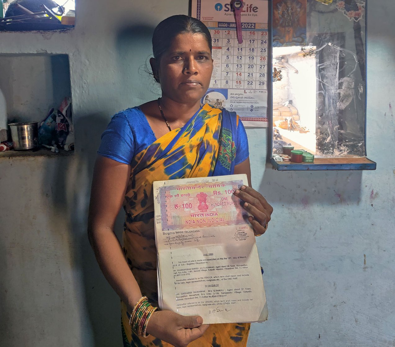 Gaddamidi Rajeshwari holding the title deed for the land she bought in 2018. ' It’s been five years now and I still haven’t received my pattadar [land owner] passbook'